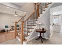 Elegant staircase with hardwood treads, white risers, and dark metal balusters at 9954 Heywood St, Highlands Ranch, CO 80130