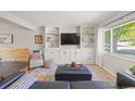 Inviting living room featuring custom built-ins, stylish decor, and a large window with abundant natural light at 13402 W 24Th Pl, Golden, CO 80401