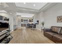 Open concept living and dining area with hardwood floors, modern furniture, and ample natural light at 7881 W 51St Ave # B, Arvada, CO 80002
