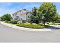 Corner lot home featuring mature trees and manicured landscaping at 17298 E Lake Pl, Aurora, CO 80016