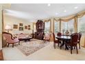 Living room and dining area with large windows and classic decor at 17298 E Lake Pl, Aurora, CO 80016