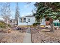 Lovely single-story home with a quaint front yard, mature trees, and inviting curb appeal at 1994 Macon St, Aurora, CO 80010
