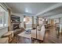Open-concept living room with fireplace and hardwood floors leading to dining area at 532 Kimmes Ln, Breckenridge, CO 80424