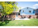 Spacious backyard with a patio, lush lawn, mature tree, and a privacy fence, perfect for outdoor entertaining at 11345 Marshall Ct, Westminster, CO 80020