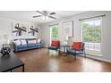Bright living room featuring wood floors, large windows, stylish furniture, and contemporary decor at 11345 Marshall Ct, Westminster, CO 80020