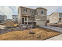 Two-story home with a covered porch, two-car garage, and neutral siding at 42729 Ivydel Cir, Elizabeth, CO 80107