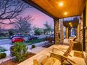 Inviting covered porch with stone pillars and comfortable seating area at 3711 Mariposa St, Denver, CO 80211