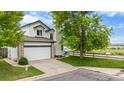 Charming two-story home with a spacious driveway, two car garage and manicured lawn at 8544 S Upham Way, Littleton, CO 80128