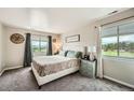 Inviting bedroom with mountain views, a comfortable bed, and neutral decor at 10872 W Evans Ave # 3D, Lakewood, CO 80227