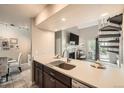 Modern kitchen with sleek countertops, stainless steel appliances, and an open view to the living space at 10872 W Evans Ave # 3D, Lakewood, CO 80227