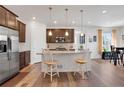 Charming kitchen boasts granite countertops, stainless steel appliances, and an inviting breakfast bar seating area at 87 Green Fee Cir, Castle Pines, CO 80108