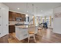 Bright kitchen featuring an island with barstool seating open to the dining area and living room at 87 Green Fee Cir, Castle Pines, CO 80108