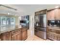 Stylish kitchen with stainless steel appliances, wooden cabinets, and granite countertops at 6338 S Oneida Ct, Centennial, CO 80111