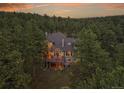 Aerial view of a home surrounded by lush forest at 29433 Firethorne Ct, Evergreen, CO 80439