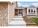 Inviting front entrance featuring stone accents, flower boxes, and a cozy seating area at 7407 E Long Cir, Centennial, CO 80112