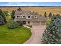 Aerial view of a spacious home with a large yard and mature trees on a sprawling property at 5861 E Valley Hi Dr, Parker, CO 80138