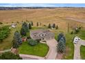 A scenic aerial view of the property showcasing the home, yard, and surrounding landscape at 5861 E Valley Hi Dr, Parker, CO 80138
