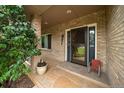 Charming front porch with brick pillars, stone flooring, and inviting entryway details at 5861 E Valley Hi Dr, Parker, CO 80138