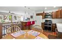 Open-concept kitchen with stainless steel appliances, breakfast bar, and dining area at 7472 Jay Ct, Arvada, CO 80003