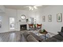 Inviting living room featuring a fireplace, neutral walls, and stylish decor at 4270 Defoe St, Strasburg, CO 80136