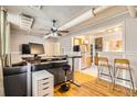 Living room with hardwood floors, ceiling fan, and kitchen view at 1376 N Pearl St # B1, Denver, CO 80203