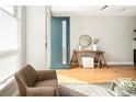 Bright entryway with stylish decor and a modern teal front door at 1581 Wolff St, Denver, CO 80204