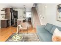 Open-concept living room features hardwood floors, modern furnishings, and a staircase leading to the upper level at 1581 Wolff St, Denver, CO 80204
