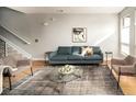 Bright and airy living room with hardwood floors, a stylish rug, and modern seating arrangement at 1581 Wolff St, Denver, CO 80204