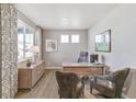 Bright home office with two chairs, stylish desk, hardwood floors, and lots of natural light at 4837 Cattle Cross Ln, Castle Rock, CO 80104