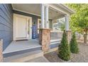 Inviting front porch with stone pillars, railing, and a 'Welcome' sign at 1540 Meachum Way, Erie, CO 80516