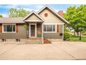 View of the front exterior showcasing its well-kept facade, including the front entryway, neutral paint and shuttered windows at 3317 Harlan St, Wheat Ridge, CO 80033