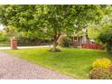 Picture perfect front yard has lush grass and mature trees surrounding this charming home on a quiet street at 3317 Harlan St, Wheat Ridge, CO 80033