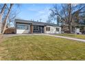 View of home showcasing a green lawn, walkway, and inviting facade with new paint at 2990 S Elm St, Denver, CO 80222