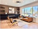 Cozy living room features modern furnishings, decorative fireplace, and a large window with natural light at 1559 S Forest St, Denver, CO 80222