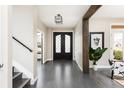 Welcoming foyer with hardwood floors, an elegant light fixture, and a decorative plant at 1214 S Fillmore St, Denver, CO 80210