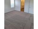 Neutrally decorated bedroom with plush carpeting and an adjoining bathroom, offering comfort and convenience at 15261 Fillmore St, Thornton, CO 80602