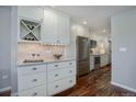 Updated kitchen featuring white cabinets, stainless steel appliances, and ample counter space at 909 N Logan St # 1B, Denver, CO 80203