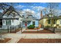 Street view of a charming home with a well-manicured front yard and black metal fence at 161 W Maple Ave, Denver, CO 80223