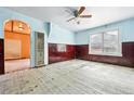 Living room showcasing light blue walls, paneled walls, and an archway at 12 Marshall Pl, Longmont, CO 80504