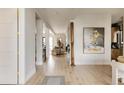 Bright foyer featuring hardwood floors, artwork, and seamless transition into the living area at 1130 S Cook St, Denver, CO 80210
