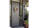 Stylish front door with a wreath and sleek design, complemented by modern hardware and house numbers at 1130 S Cook St, Denver, CO 80210