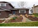 Charming home featuring a brick facade, well-manicured garden, and inviting front door at 8229 Estes Ct, Arvada, CO 80005