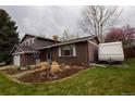 Charming home featuring a brick facade, well-manicured garden, and RV parking at 8229 Estes Ct, Arvada, CO 80005