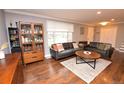Inviting living room with hardwood floors, stylish furniture, and ample natural light from the large window at 8229 Estes Ct, Arvada, CO 80005