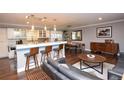 Bright, open-concept living space with a modern kitchen, dining area, and comfortable seating at 8229 Estes Ct, Arvada, CO 80005