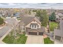 Aerial view of a well-maintained two-story home with an attached garage in a lovely neighborhood at 2649 S Kline Cir, Lakewood, CO 80227