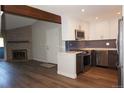 Renovated kitchen featuring stainless steel appliances, subway tile backsplash, and wood beam at 12033 E Harvard Ave # 208, Aurora, CO 80014