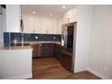 Updated kitchen with stainless steel appliances, modern cabinetry, and backsplash at 12033 E Harvard Ave # 208, Aurora, CO 80014