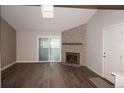 Bright living room features a decorative fireplace, hardwood floors, and sliding glass doors at 12033 E Harvard Ave # 208, Aurora, CO 80014