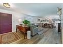 Open-concept living room featuring wood floors, ample natural light, and stylish furnishings at 3844 S Elm St, Denver, CO 80237